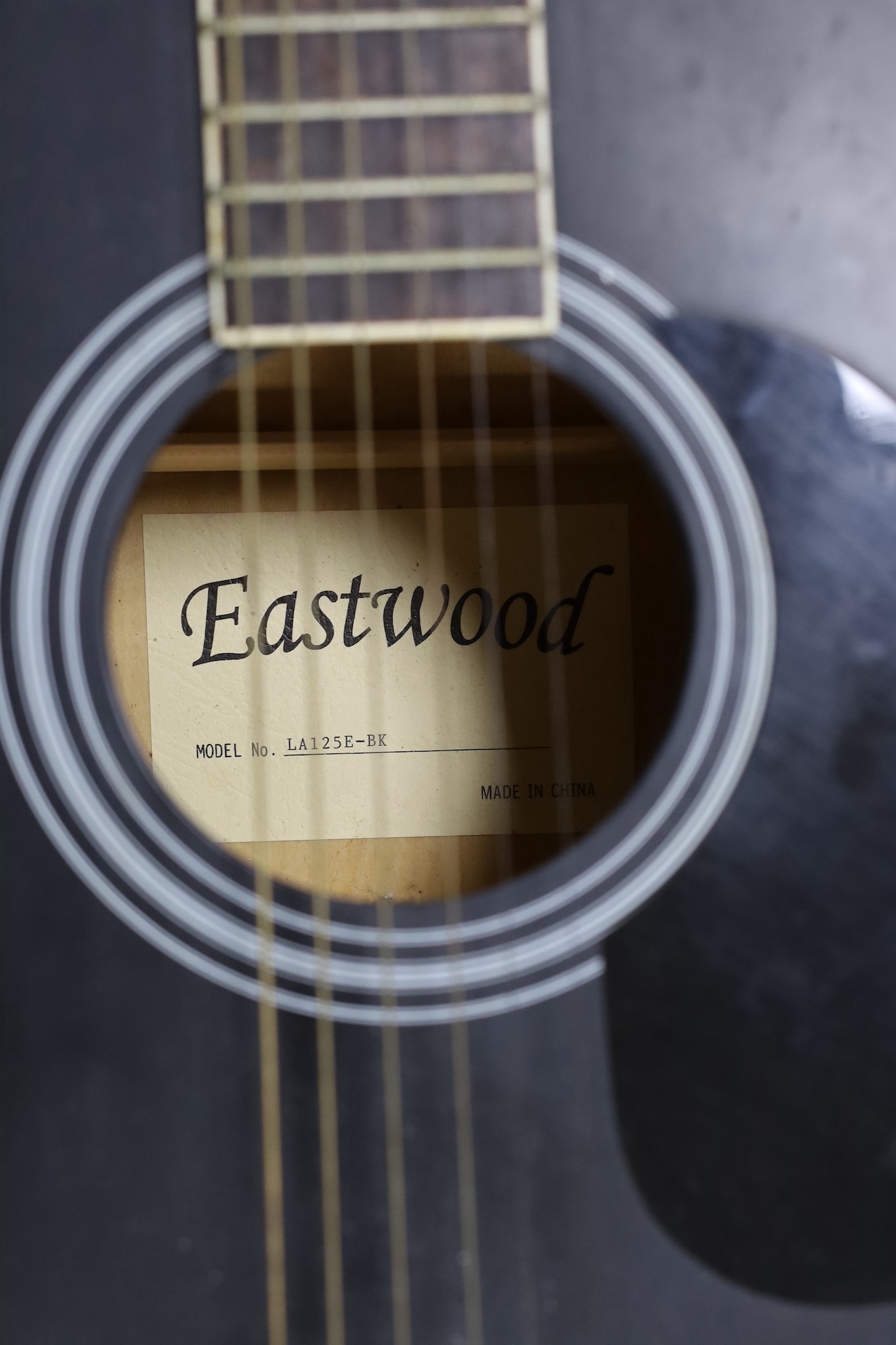 An Eastwoods acoustic guitar, 105cms high